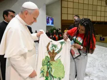 Papa Leão XIV recebe da militante do MST Ayala Ferreira uma imagem de orixá feita com miçangas do candomblé.