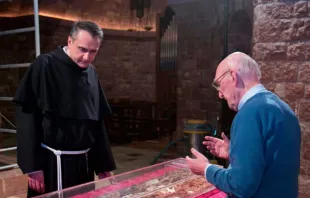 Abertura do túmulo de São Francisco de Assis em 2015, mostrando o então custódio do Sacro Convento, padre Mauro Gambetti, inspecionando os restos mortais do santo.