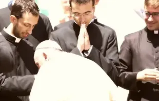 O papa Francisco beija as mãos de um grupo de sacerdotes recém-ordenados