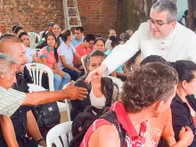 Dom Victor Manuel Ochoa Cadavid com um grupo de migrantes 