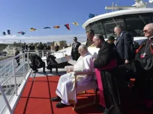 Papa Francisco acena para as crianças enquanto espera a bordo de um catamarã - Crédito: Vatican Media